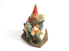 UpperDutch:Gnome,Gnome with grandchildren sitting in a chair figurine. 'Grandfather with Children' Part of the Classic Gnomes series designed by Rien Poortvliet
