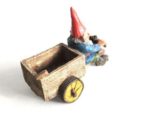 UpperDutch:,'Thomas' Gnome riding a cargo bike with shovel. Gnome figurine after a design by Rien Poortvliet. Classic Gnomes series. AAAAAAA International Co. Ltd.