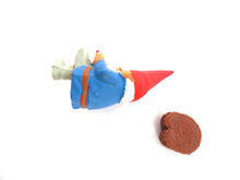 UpperDutch:Gnomes,Gnome, miniature Gnome after a design by Rien Poortvliet, Brb Gnome, David the Gnome, reading gnome sitting on a tree trunk.