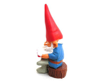 UpperDutch:Gnomes,Gnome, miniature Gnome after a design by Rien Poortvliet, Brb Gnome, David the Gnome, reading gnome sitting on a tree trunk.