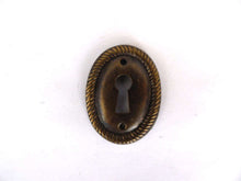 UpperDutch:Hooks and Hardware,1 (ONE) small Oval Stamped Keyhole cover, Antique brass escutcheon, key hole frame, plate.