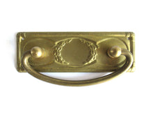 UpperDutch:Hooks and Hardware,1 (ONE) Old cabinet pull escutcheon with laurel design. NOS Brass Antique Drawer Handle with hanging pull. Restoration hardware.
