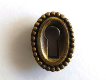 UpperDutch:Hooks and Hardware,1 Vintage small oval keyhole cover. Cast brass escutcheon for jewelry making, furniture decoration. Distressed hardware.