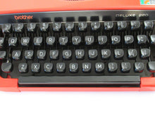 UpperDutch:Typewriter,Brother Deluxe 220 working typewriter. Red metal body, two tone ink ribbon. Portable writing machine. Office decor QWERTY layout
