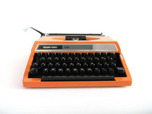 UpperDutch:Typewriter,Silver-Reed 100 working typewriter made in 1976. 1970's Orange typewriter, Silver Seiko Co Japanese QWERTY writing machine